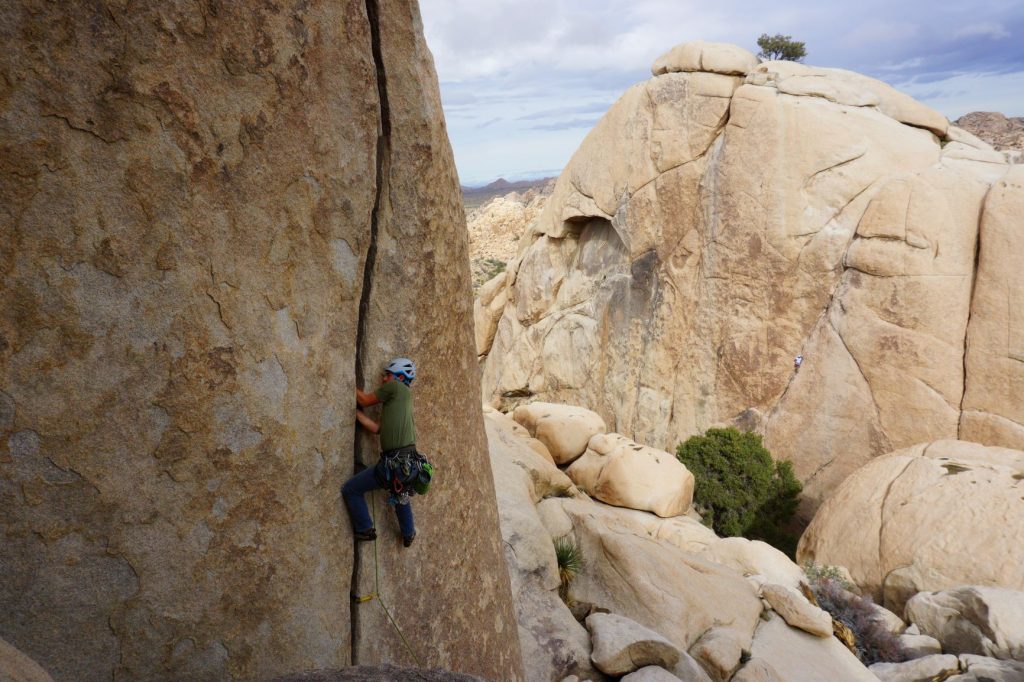 A rock climber on the route Fisticuffs in Joshua Tree National Park